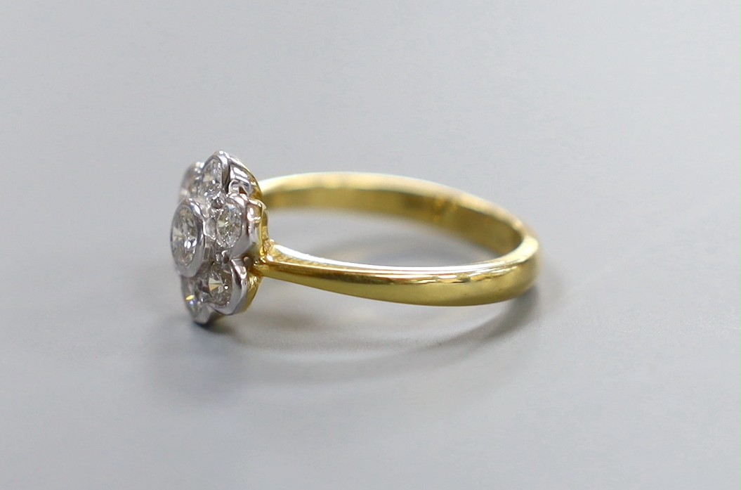 A modern 18ct gold and seven stone collet set diamond flower head cluster ring, size O, gross weight 4.4 grams